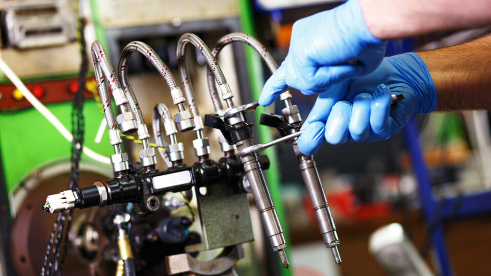 Mechanic testing diesel injector